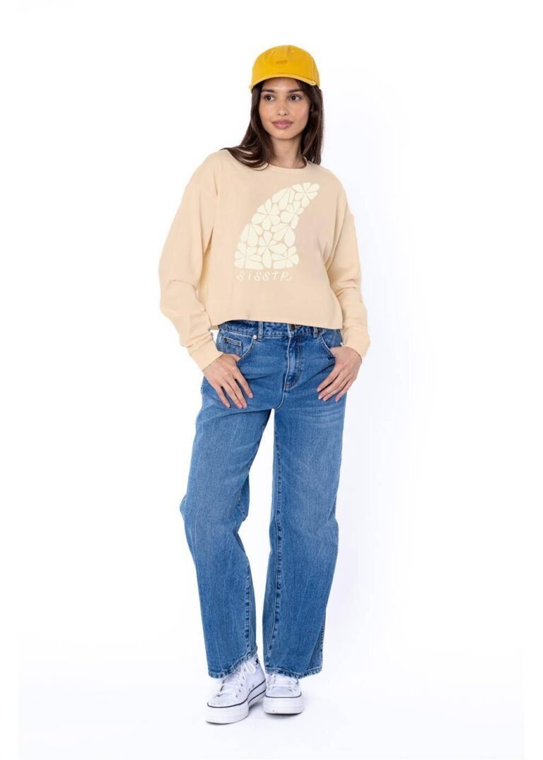 Sisstrevolution Floral Fin Crop LS Knit Tee in shell color, featuring a floral graphic on the front, styled with blue jeans.