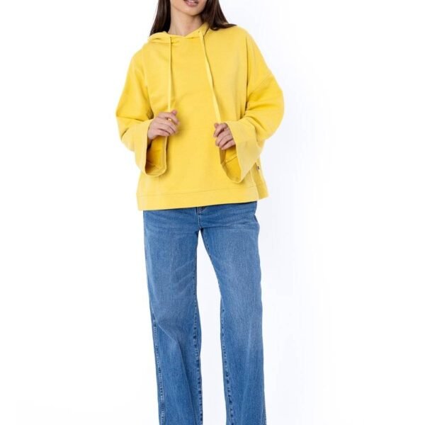 Woman wearing Sisstr Fort Baker Ls Fleece in yellow with bell sleeves and front pocket.
