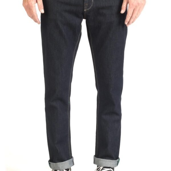 Front view of Vissla Profile Denim 5 Pkt Pant in dark wash with cuffed hem.