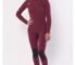 Woman wearing a maroon Sisstrevolution winter wetsuit, showcasing its stylish and warm design.