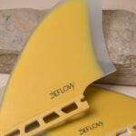 Close-up of Deflow Palm twin fin in mustard color with detailed texture.